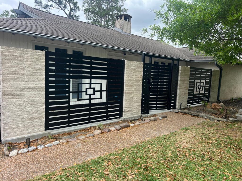 Custom black steel fence panels with geometric square medallions and matching pedestrian gate