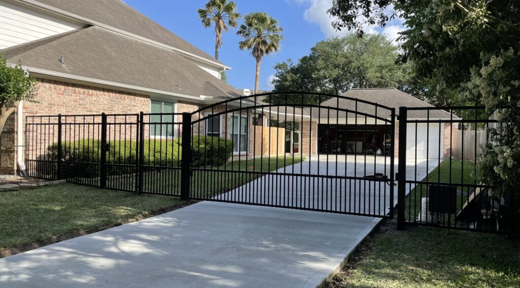 Electric iron driveway gate on a residential concrete drive