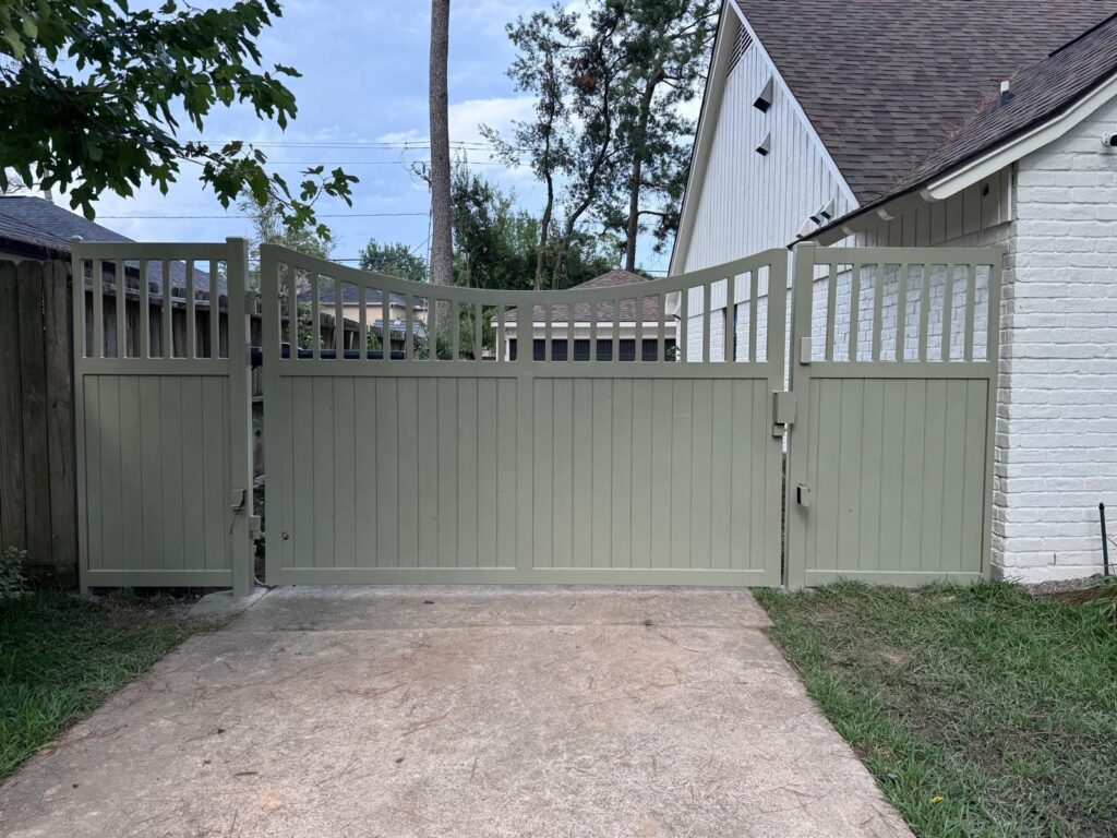 Sage painted wood driveway gate with open slat top rail and pedestrian gate